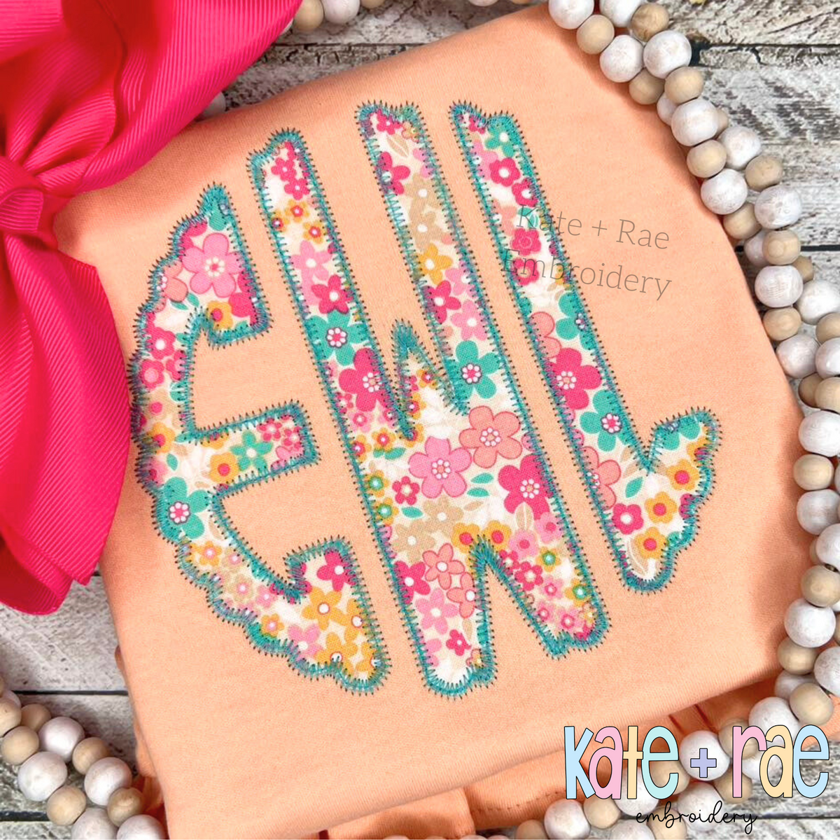 Scalloped Monogram Zigzag Stitch Applique Embroidery Font: Pink and teal floral scalloped zigzag applique monogram on a peach shirt