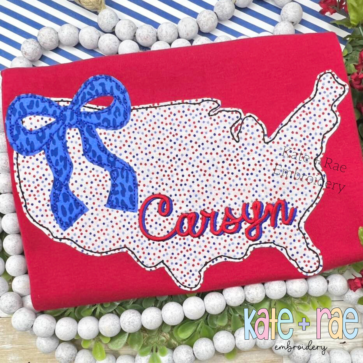 Red speckled America outline applique with a blue leopard bow and the name Carsyn on a red shirt