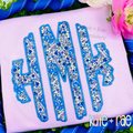 Scalloped Monogram Zigzag Stitch Applique Embroidery Font: Blue floral scalloped zigzag applique monogram on a lavender shirt