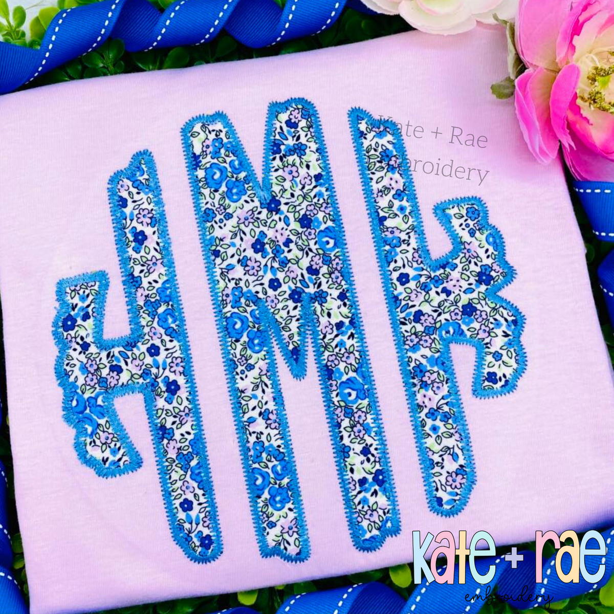 Scalloped Monogram Zigzag Stitch Applique Embroidery Font: Blue floral scalloped zigzag applique monogram on a lavender shirt