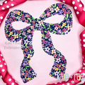Merritt Bow Bean Stitch Applique Embroidery Design: Navy floral Merritt bow bean stitch applique on a pink shirt
