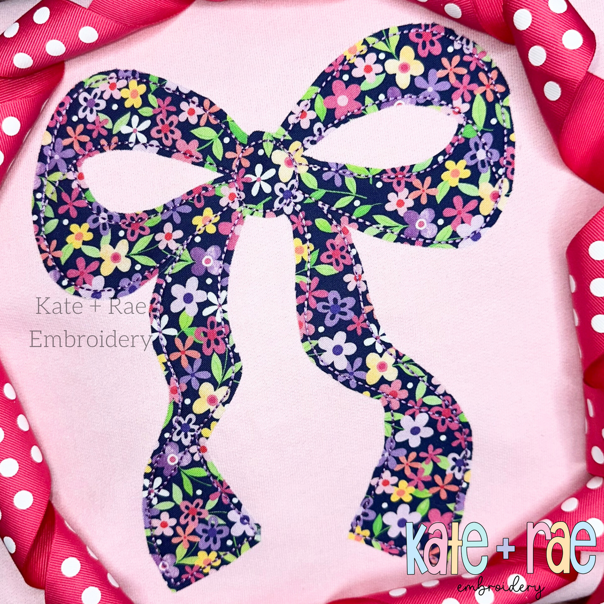 Merritt Bow Bean Stitch Applique Embroidery Design: Navy floral Merritt bow bean stitch applique on a pink shirt