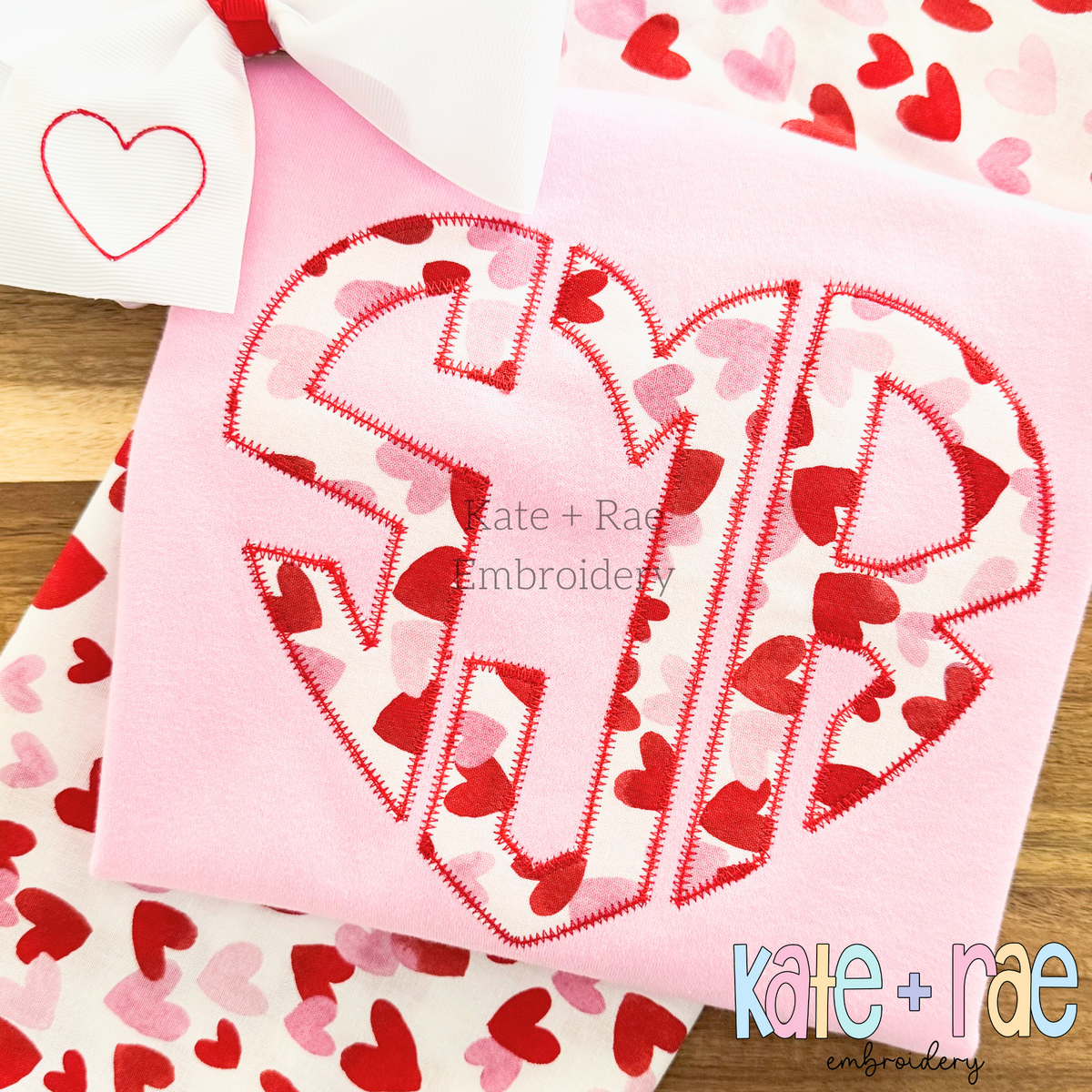 Heart Monogram Zigzag Stitch Applique Embroidery Design: Heart shaped monogram SJR in heart print zigzag applique on a pink shirt