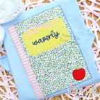 Girl's Back to School Notebook Zigzag Applique Embroidery Design: Floral notebook applique with a bow and the name waverly on a yellow label on a light blue shirt