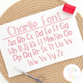 Charlie Bean Stitch Embroidery Font: The words Charlie Font and full upper and lowercase alphabet in pink bean stitch on white fabric