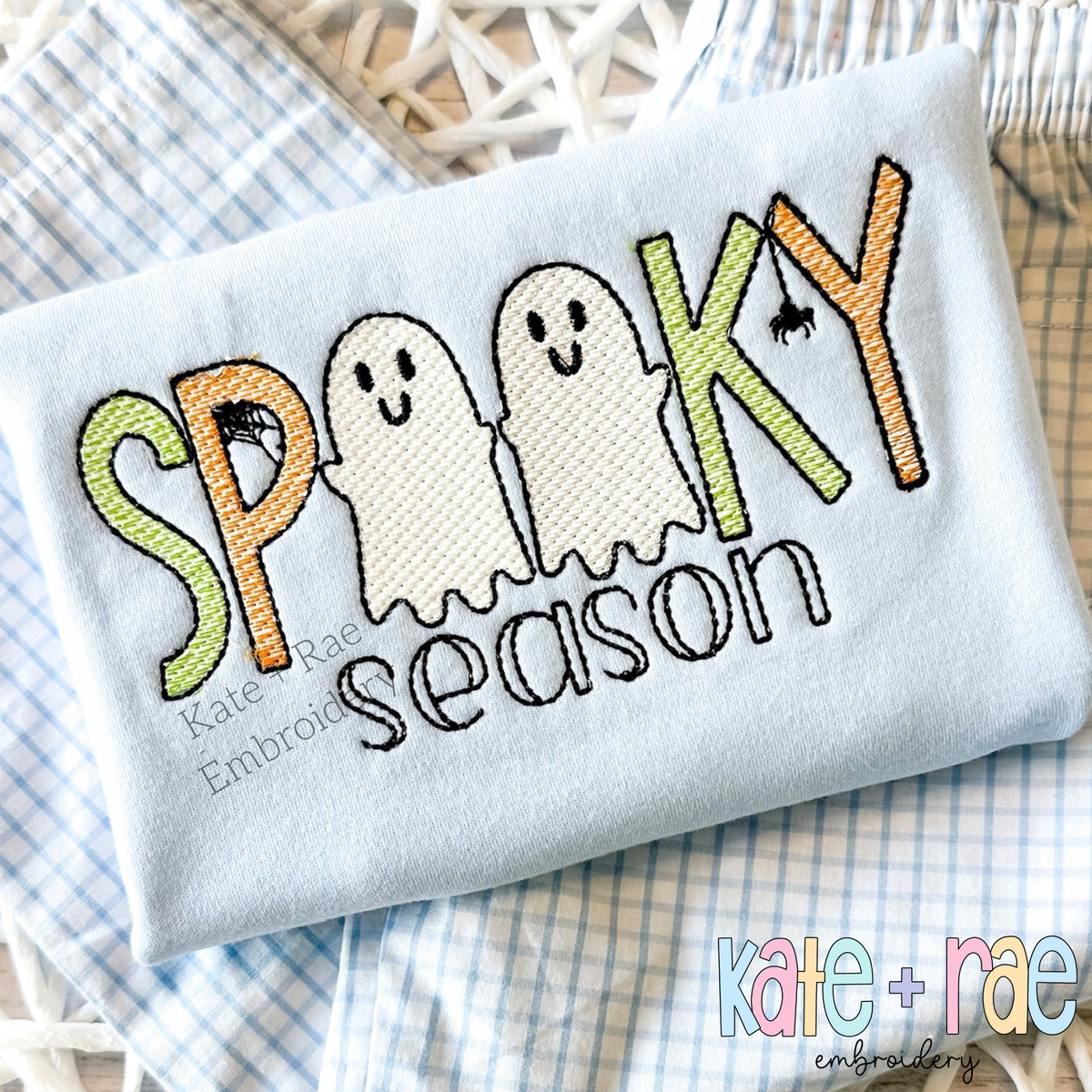 Boys Spooky Season Sketch Stitch Embroidery Design: SPOOKY with smiling sketch ghosts and a spider above season on a light blue shirt