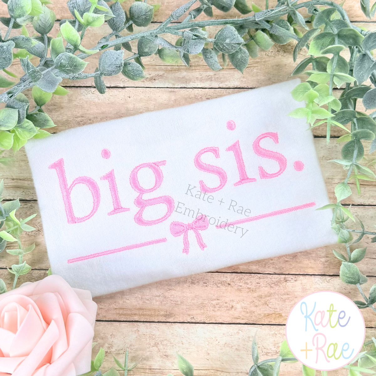 Big Sis with Bow Satin Stitch Embroidery Design: Big sis. in pink satin lettering with a bow on a white pillowcase