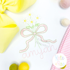 Daisy Floral Bow Mini Satin Stitch Embroidery Design: Daisy bouquet tied with a pink bow above the name amyjah in pink on a white shirt
