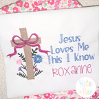 Cross Stitch Floral Cross Embroidery Design: Tan cross stitch floral cross with a bow beside Jesus Loves Me This I Know and the name ROXANNE