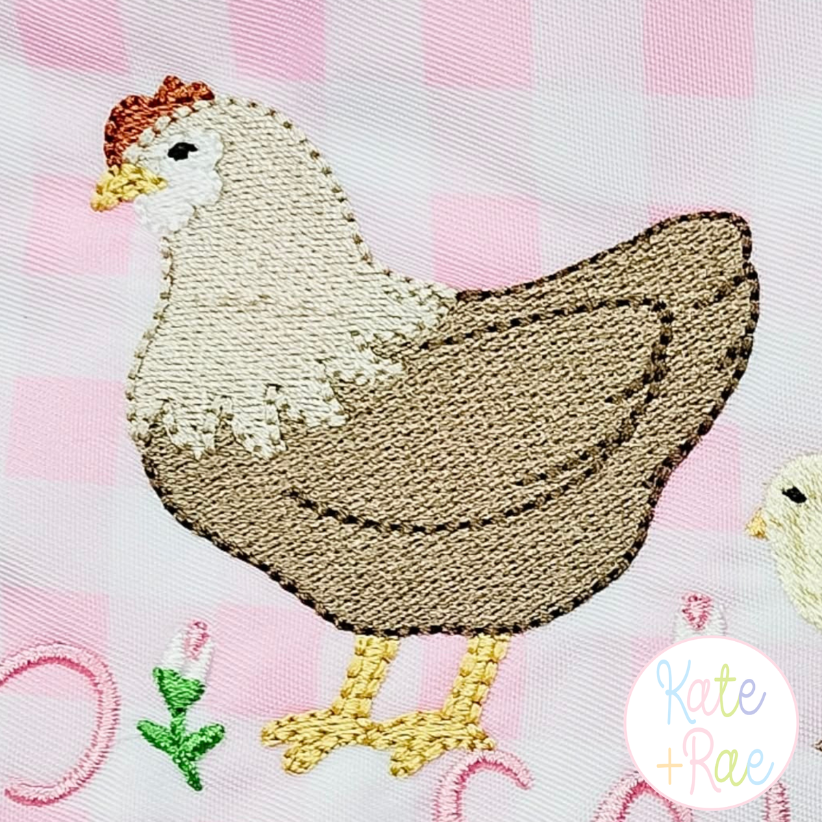 Chicken Mini Fill Embroidery Design: Close-up of a stitched tan and cream mini fill hen on pink gingham fabric
