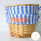 Cupcake 3D Puff Embroidery Font: The name grayson in orange 3D puff letters on a blue striped Easter basket liner