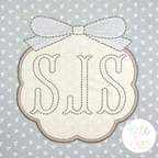 Scallop Circle Monogram Frame with Bow Satin Applique Embroidery Design: Cream scallop frame with a white bow around an SJS monogram on gray print fabric