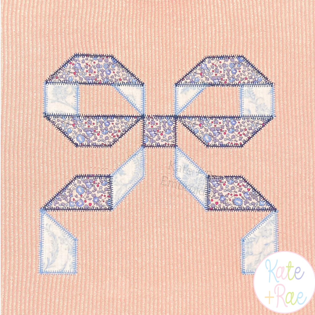 Quilt Block Bow 2 Zigzag Applique Embroidery Design: Blue floral and white quilt block bow applique on a peach corduroy shirt