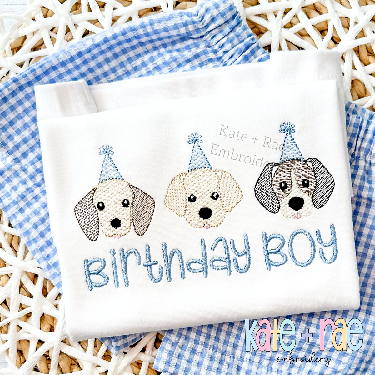 Birthday Puppies Trio Sketch Stitch Embroidery Design: Three puppy faces in blue party hats above Birthday Boy in blue sketch letters on a white shirt