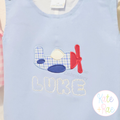 Airplane Satin Stitch Applique Embroidery Design: Blue gingham airplane applique above LUKE in white letters on a light blue jon jon
