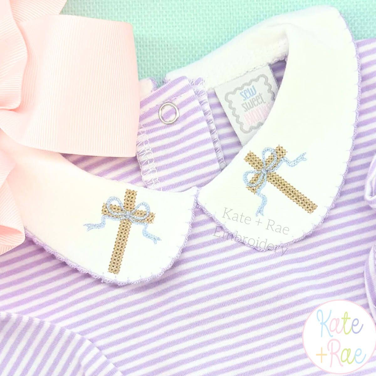 Cross Stitch Mini Cross with Bow Embroidery Design: Close-up of tan mini cross stitch crosses with blue bows on a white collar