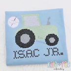 Tractor Cross Stitch Embroidery Design: Light green tractor cross stitch above ISAC JR. in black cross stitch letters on a light blue shirt