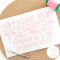 Happy Days Bean Stitch Embroidery Font: Upper and lowercase alphabet in the Happy Days bean font stitched in pink on white fabric