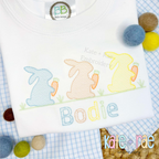 Boy's Easter Bunny with Carrots Trio Sketch Stitch Embroidery Design: Three pastel sketch bunnies holding carrots above the name Bodie on a white shirt