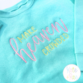 Make Heaven Crowded Satin Stitch Embroidery Design: Make Heaven Crowded in pink and yellow satin lettering on an aqua sweatshirt