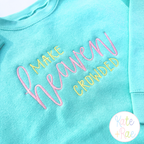 Make Heaven Crowded Satin Stitch Embroidery Design: Make Heaven Crowded in pink and yellow satin lettering on an aqua sweatshirt