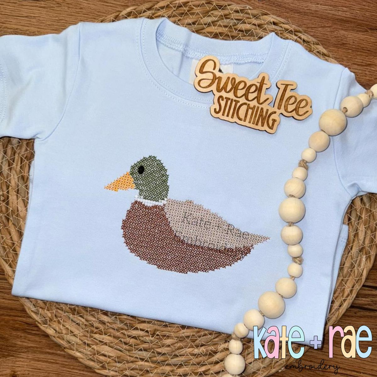 Mallard Duck Cross Stitch Embroidery Design: Mallard duck cross stitch on a light blue tee