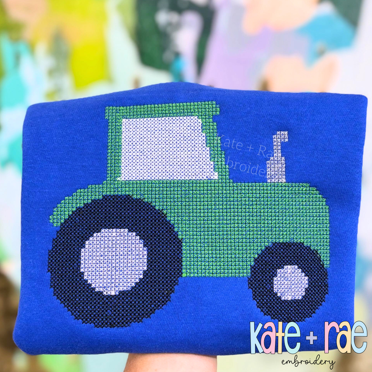 Tractor Cross Stitch Embroidery Design: Green tractor cross stitch on a royal blue sweater