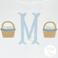 Boy's Simple Easter Basket Mini Fill Embroidery Design: Light blue cross stitch monogram letter M between two small Easter baskets on white fabric