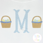 Boy's Simple Easter Basket Mini Fill Embroidery Design: Light blue cross stitch monogram letter M between two small Easter baskets on white fabric