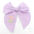 Mini Tulip Cross Stitch Embroidery Design: Small pink cross stitch tulip on a lavender fabric hair bow