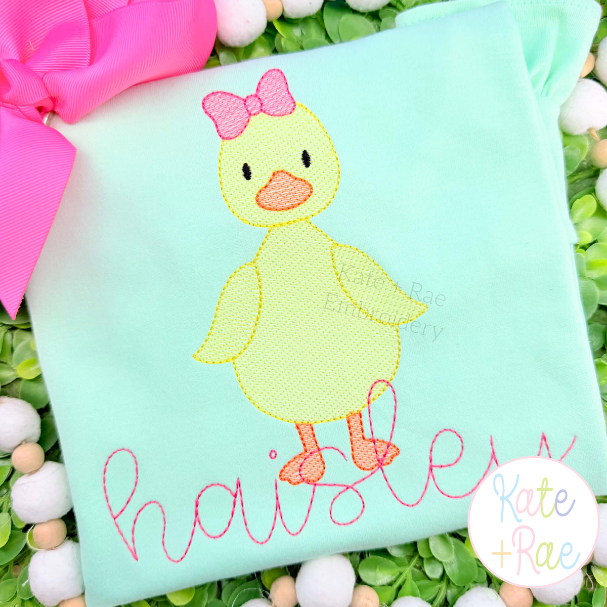 Girl Duck with Bow Sketch Stitch Embroidery Design: Yellow sketch duck with a pink bow above the name haisley in pink script on a mint shirt