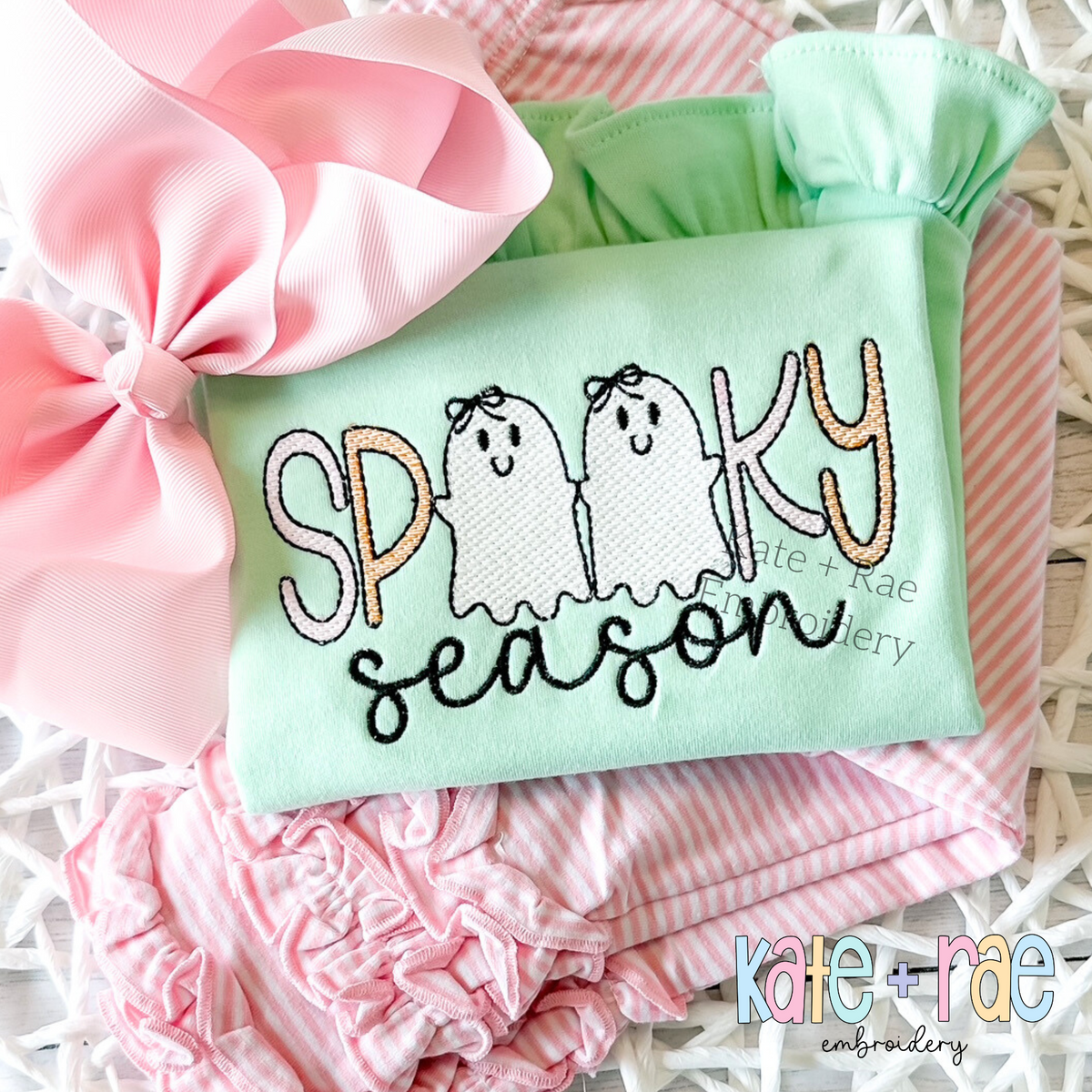 Girls Spooky Season Sketch Stitch Embroidery Design: SPOOKY with two ghosts wearing bows above season in black script on a mint ruffle top