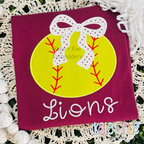 Baseball/ Softball with Merritt Bow Satin Stitch Embroidery Design: Yellow softball applique with a white polka dot bow above the word Lions in white script on a maroon shirt