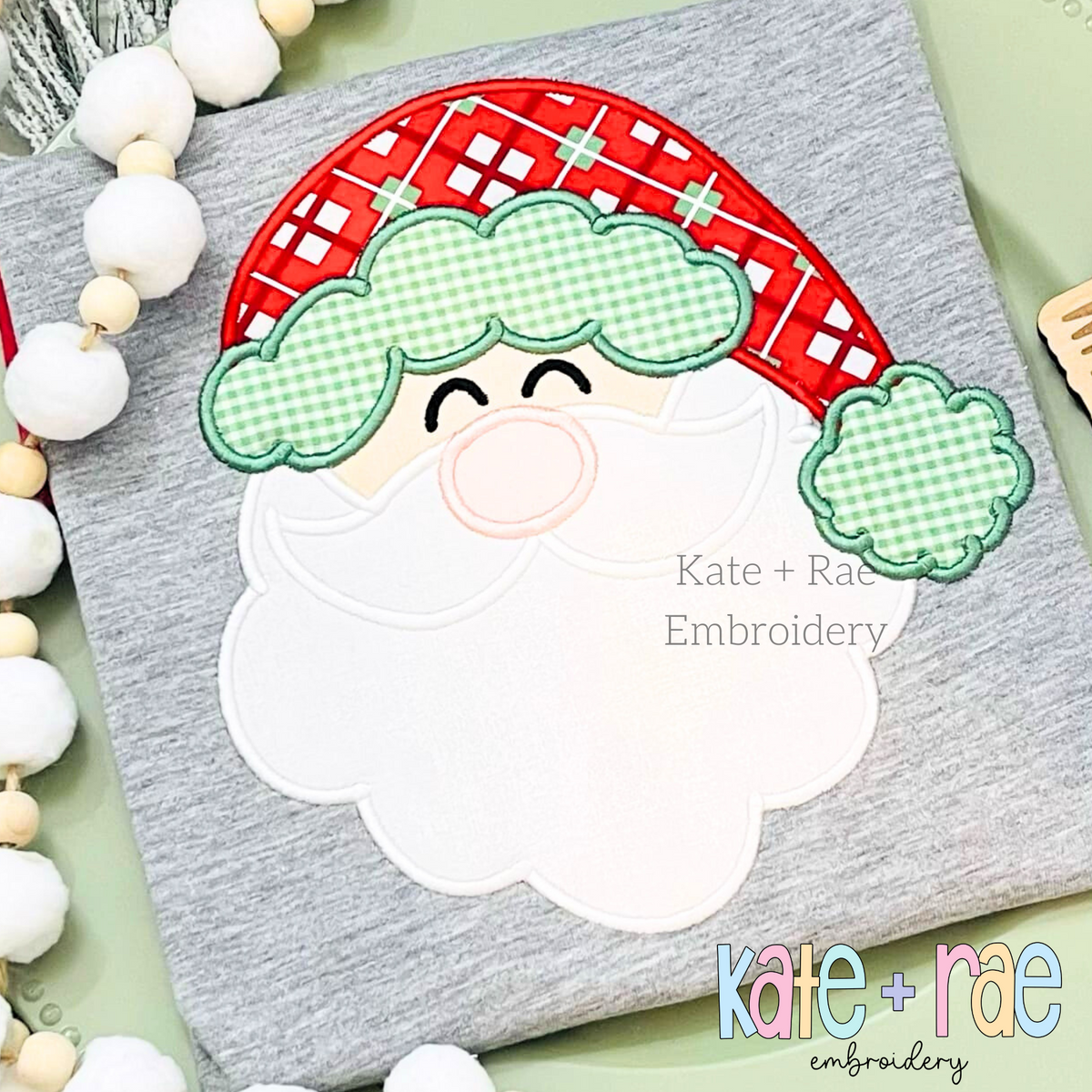 Santa Claus Satin Stitch Applique Embroidery Font: Santa face applique with a red plaid hat and green gingham trim on a gray shirt