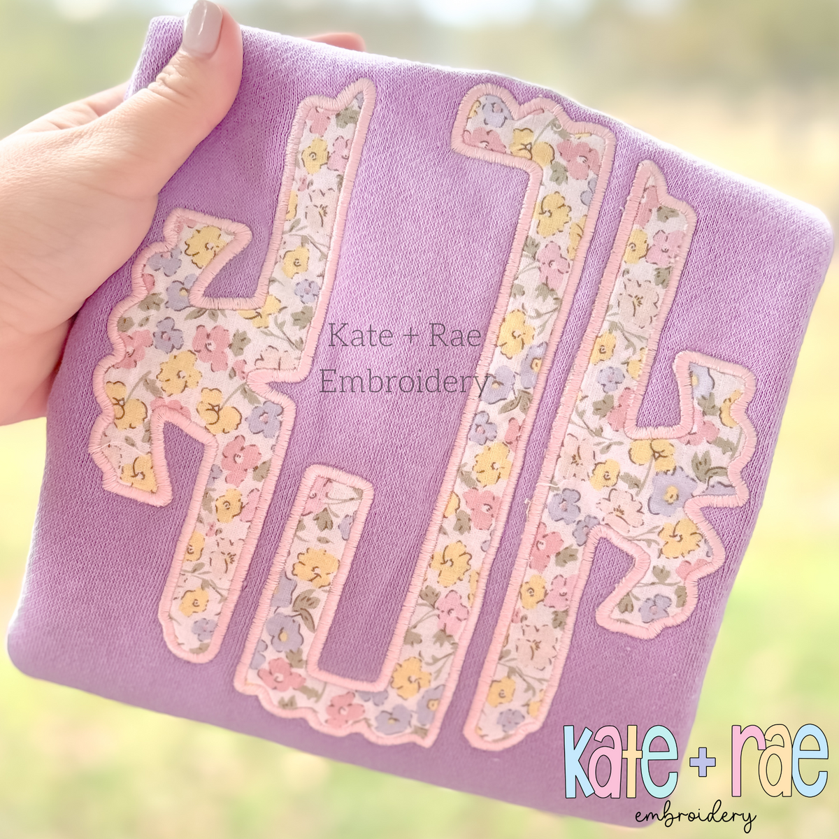 Scalloped Monogram Satin Stitch Applique Embroidery Font: Scalloped monogram in pastel floral satin applique on a lavender sweatshirt