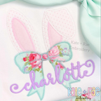 Easter Bunny Ears with Kinley Bow Zigzag Stitch Applique Embroidery Design: Pink bunny ears with a mint floral bow above the name charlotte in purple script
