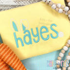 Easter Bunny Ears and Tail Font Add On Fill Stitch Embroidery Design: Bunny ears and tail add on with the name hayes in aqua on a yellow shirt