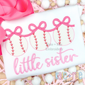 Baseball Trio with Connecting Bows Sketch Stitch Embroidery Design: Three sketch stitch baseballs linked by pink bows above the words little sister in pink script on a white shirt