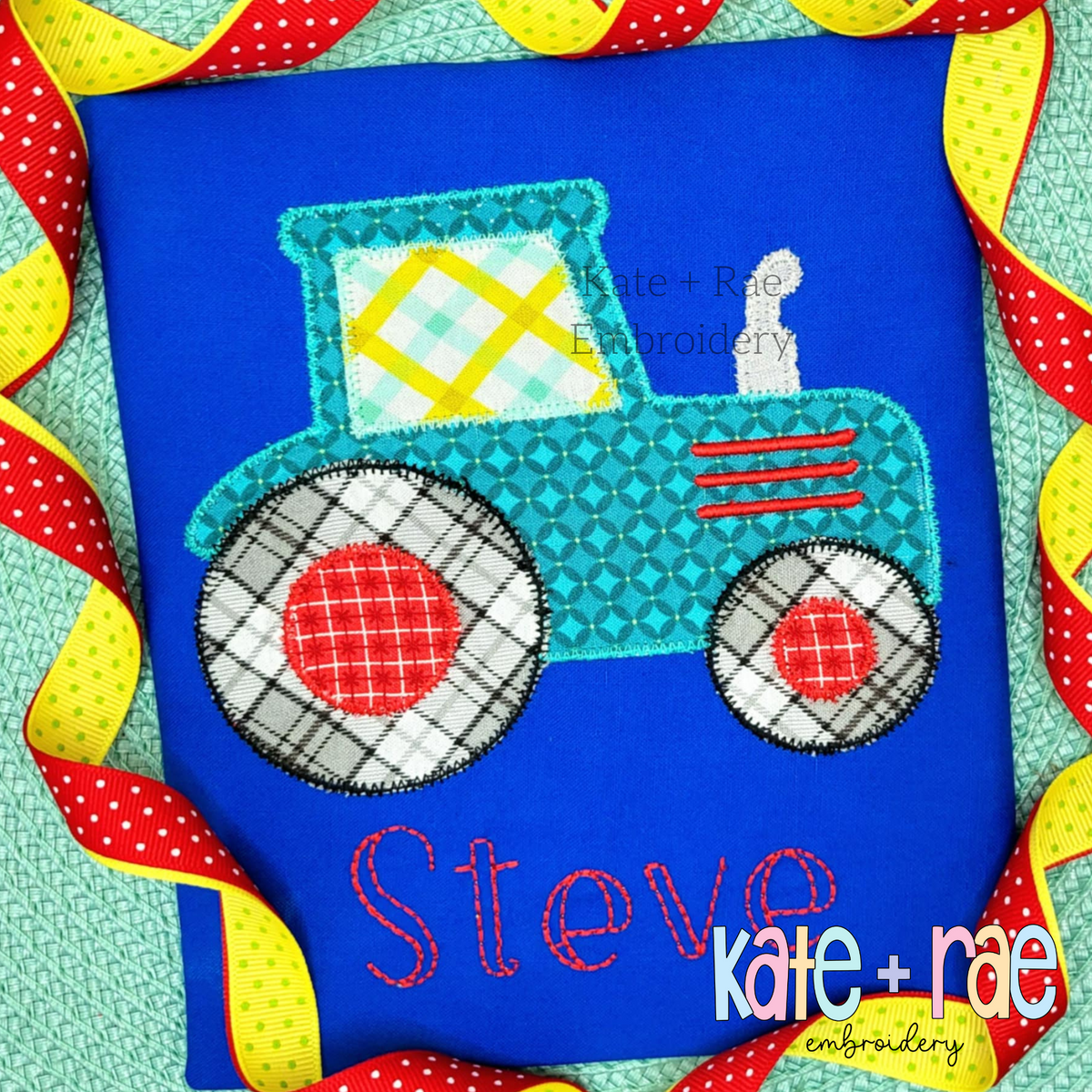 Teal patterned tractor applique with red wheels above the name Steve in red on a blue shirt