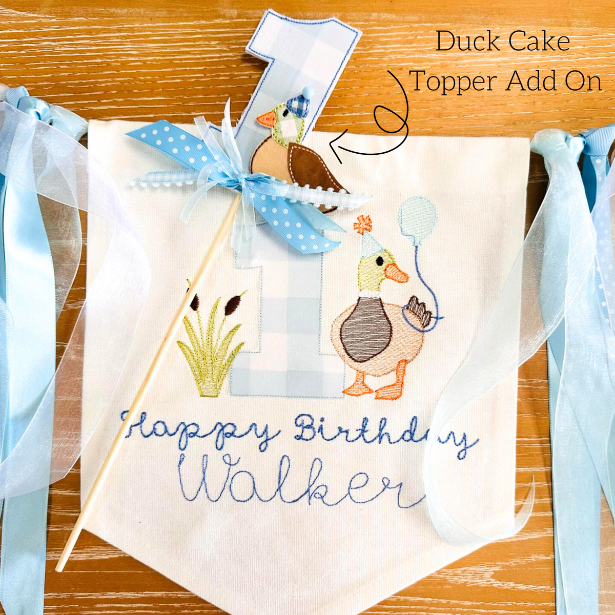 Mallard Duck Bean Stitch Applique Cake Topper Add On Embroidery Design: Duck cake topper add on with a blue gingham number 1 beside a Happy Birthday Walker banner