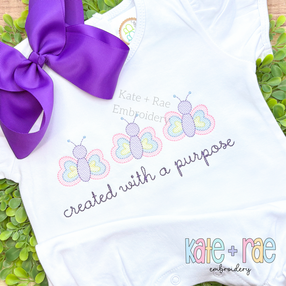 Butterfly Trio Sketch Stitch Embroidery Design: Three pastel sketch butterflies above created with a purpose in gray script on a white shirt