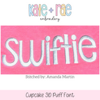 Cupcake 3D Puff Embroidery Font: The word swiftie in white 3D puff letters on a pink sweatshirt