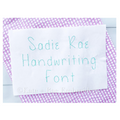 Sadie Rae Handwriting Embroidery Font: The words Sadie Rae Handwriting Font stitched in mint thread on white fabric over purple gingham