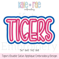 Tigers Double Satin Stitch Applique Embroidery Design: Design preview of the word TIGERS in pink letters with a white and blue double outline, available in 5x7, 6x10, 7x12, and 8x8