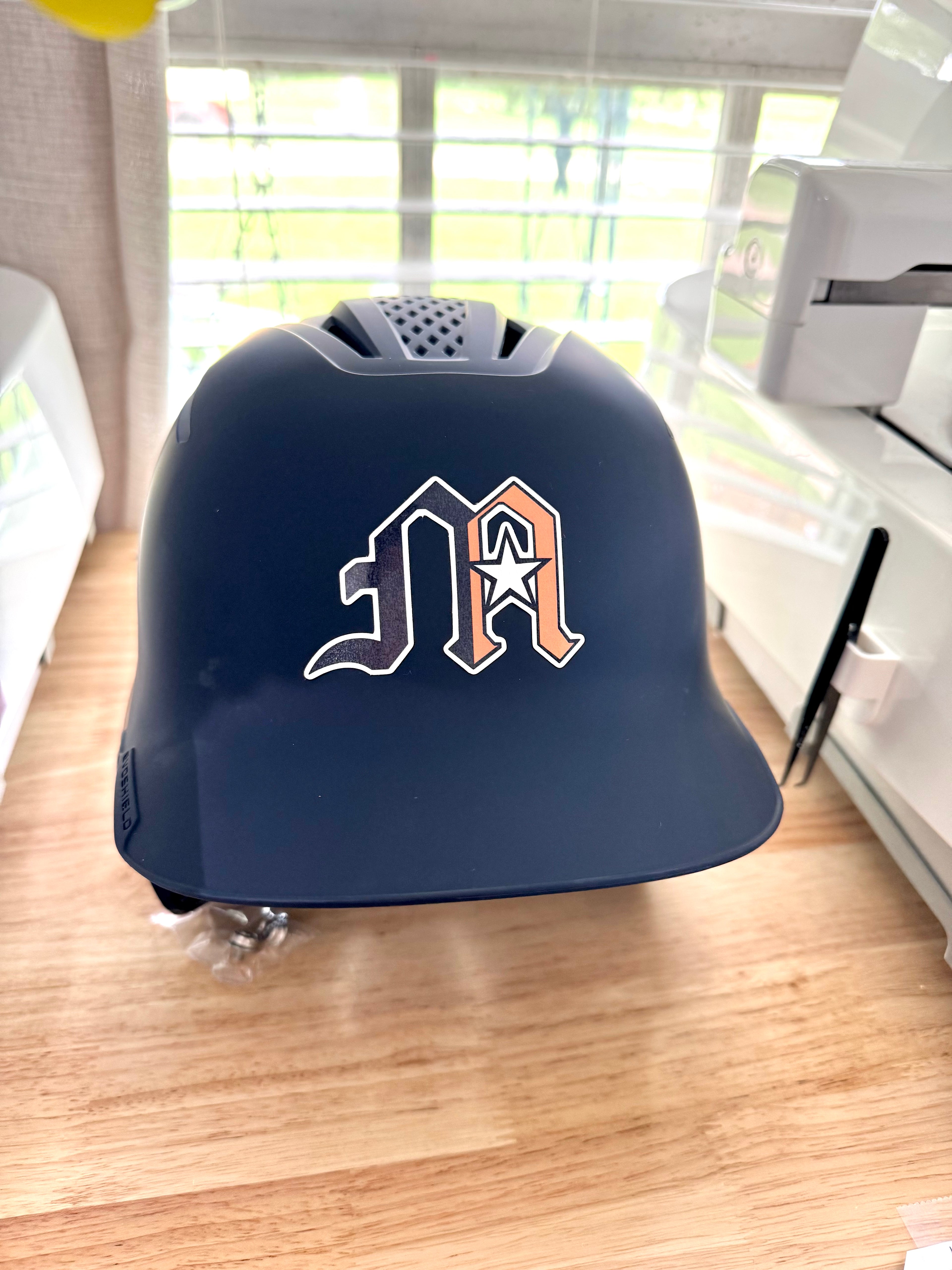 Montgomery American Helmet Stickers: Navy batting helmet with a navy and orange M logo sticker with a star