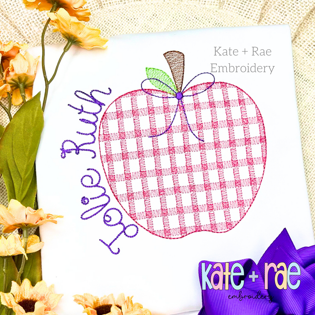 Girl's Plaid Filled Apple Embroidery Design: Pink plaid apple with a purple bow beside the name Jolie Ruth in purple script on a white shirt