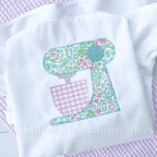Baking Mixer Zigzag Applique Embroidery Design: Stand mixer applique in teal floral fabric with a pink gingham bowl stitched on a white shirt