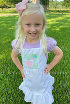 Baking Mixer Zigzag Applique Embroidery Design: Smiling girl wearing a white ruffled apron with a floral stand mixer applique