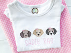 Girl Puppy Dog Trio Sketch Stitch Embroidery Design: Three small puppy faces with pink bows above the name Sadie Rae on a white shirt over pink gingham
