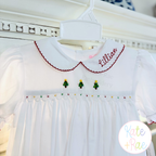 Delilah Bean Stitch Embroidery Font: The name Lillian in red bean stitch script on the collar of a white smocked Christmas dress